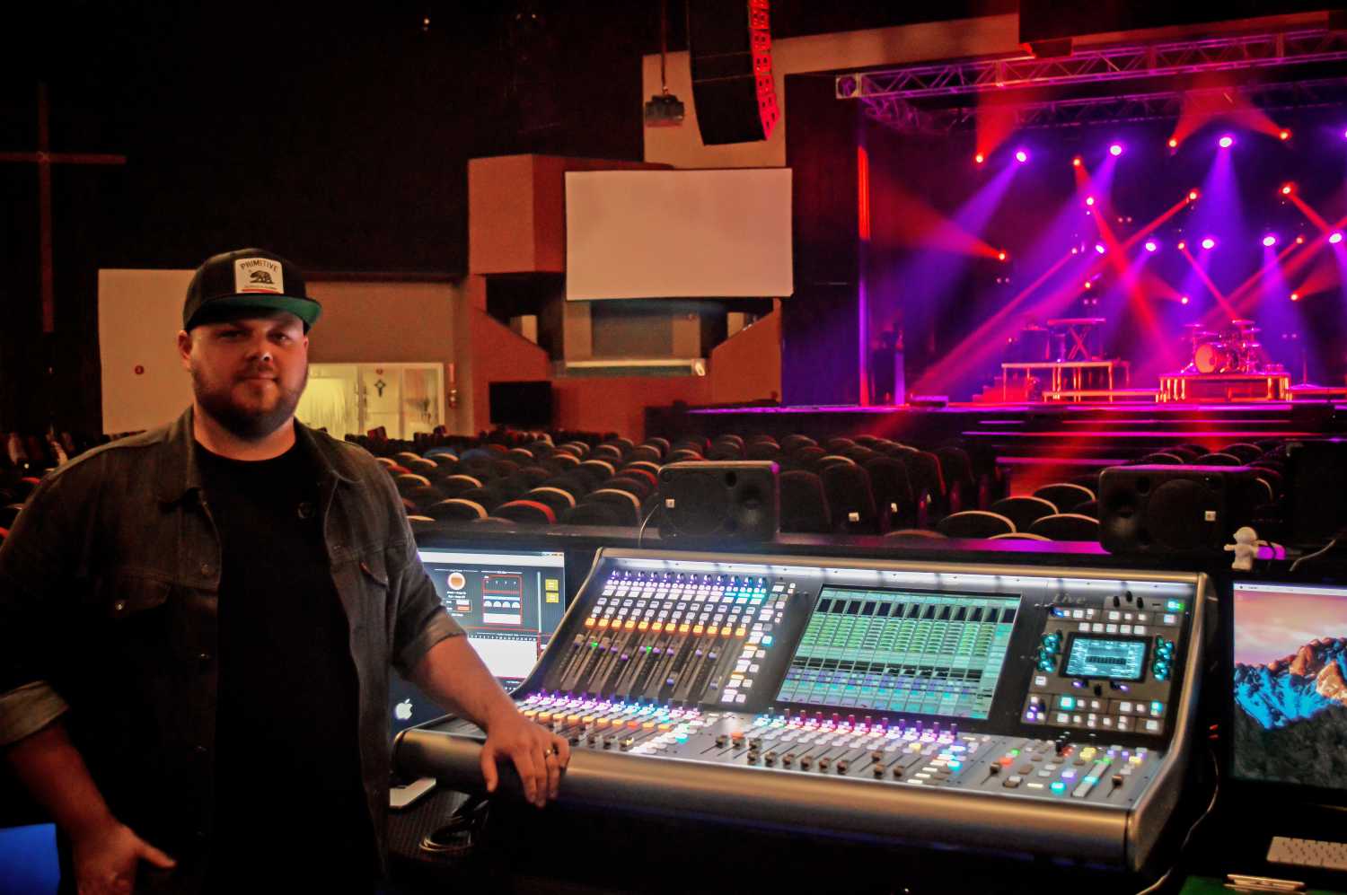 Technical director and FOH engineer Tyler DeYoung with the SSL L500 at FOH in the main auditorium