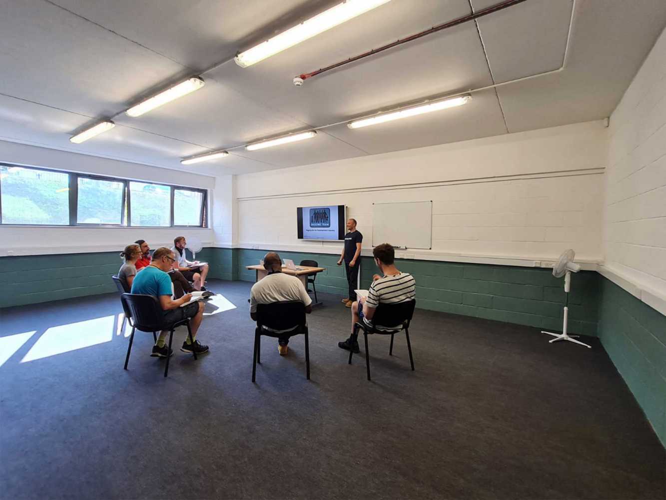 The centre features a generous classroom and presentation space, along with a practical training area