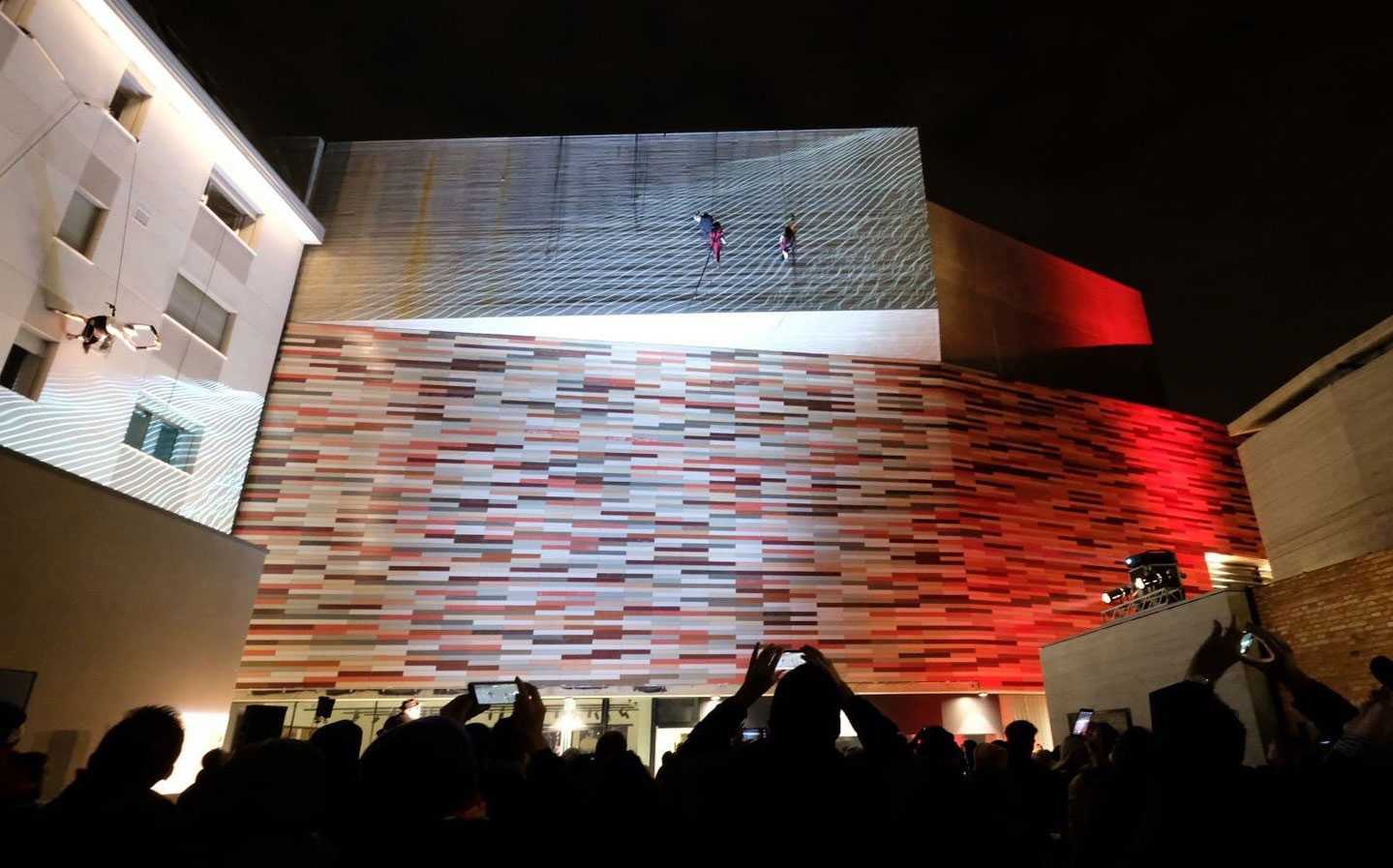 The vertical dance show took place across the ceramic-tiled façade of the building.