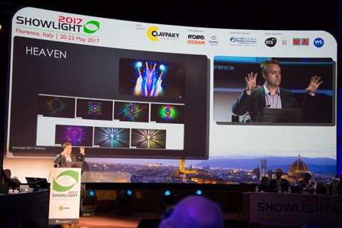 Pictured: Declan Randall presents at Showlight 2017. Sponsors benefit from branding at the event, as seen on screen.