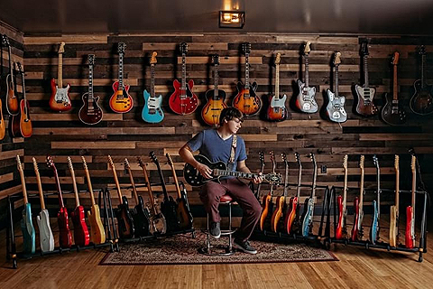 Dillon Taylor with his guitar collection at Dillon's Garage