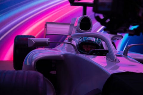 The commercial features extreme close-ups of a Formula 1 race car cockpit